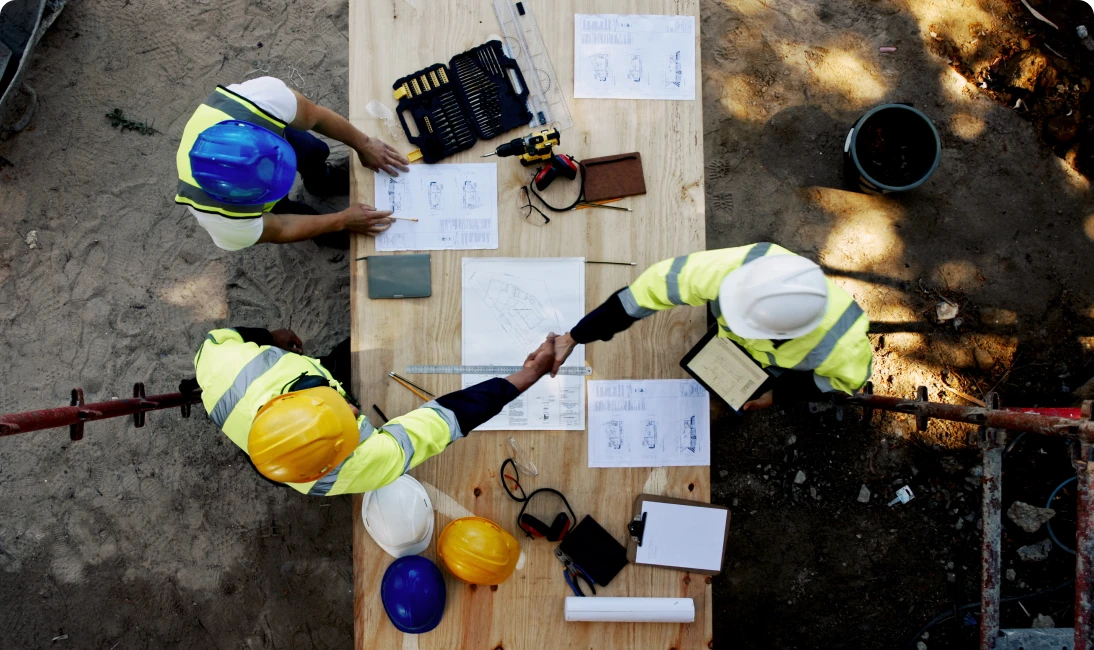 Construction workers reviewing blueprints
